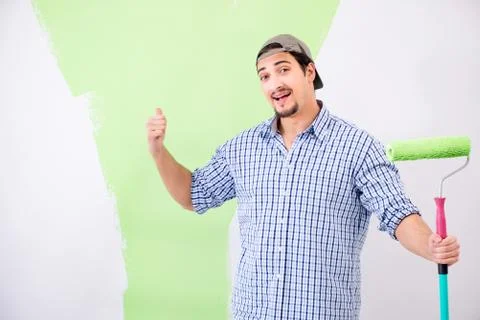 Young painter doing renovation at home Fotos Stock