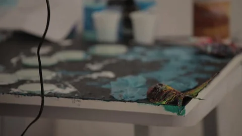 A young painter paste layers Stock Footage 86458094