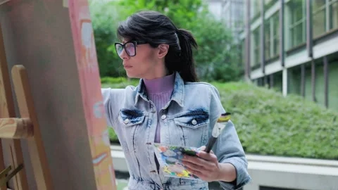 Young painter working on canvas art painting outdoor Stock Footage 196472272