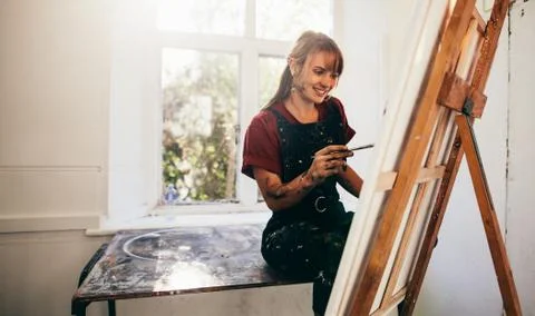 Young painter working in her studio Stock Photos