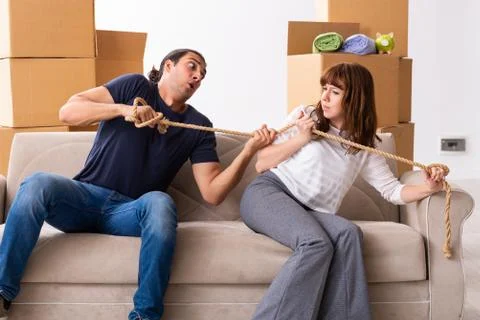 Young pair and many boxes in divorce settlement concept Fotos Stock