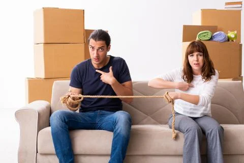 Young pair and many boxes in divorce settlement concept Fotos Stock