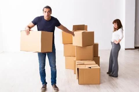 Young pair and many boxes in divorce settlement concept Fotos Stock