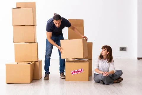 Young pair and many boxes in divorce settlement concept Fotos Stock