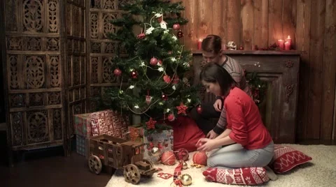 The young pair decorates a Christmas tree for Christmas Stock Footage 56526794