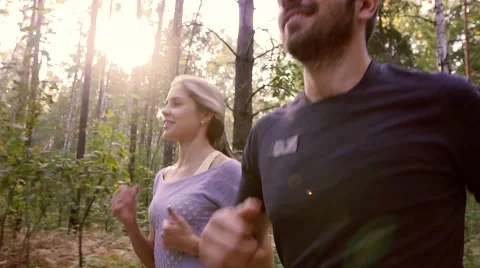 Young pair jogging on a paved road in nature Stockbeeldmateriaal 68057210
