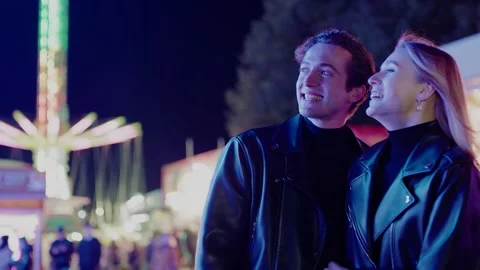 Young Pair Look at Funny Carousel and Communicate . Vídeo Stock 142159285