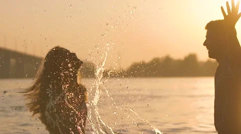 Young pair playing in water on sunset Stock-Footage 68060975