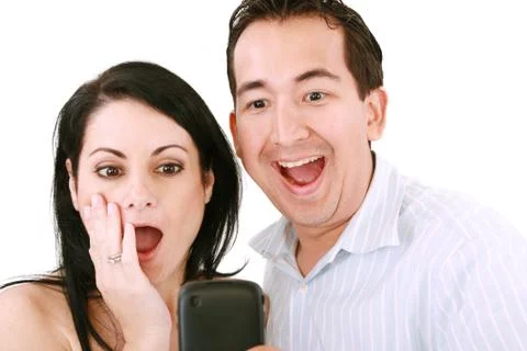 Young pair was surprised, having read on mobile phone sms. Stock Photos