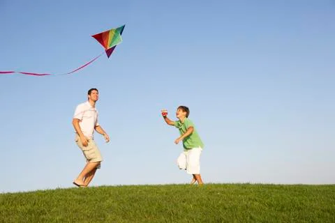 Young parent, father with child, playing in a field Stock Photos