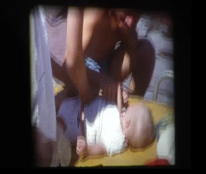 Young parents Changing babies diaper at pool Stock Footage 33831137