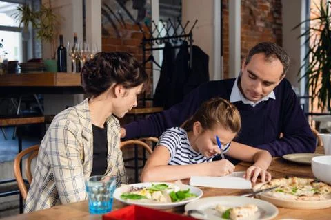 Young parents checking their daughter's homework. There are a few things to Stock Photos