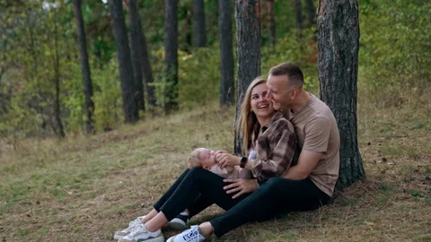 Young parents having good time with their baby in the nature.  Stock Footage 252564415