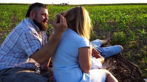Young parents with two sons spending time together at corn meadow. Family Stock Footage 297362064