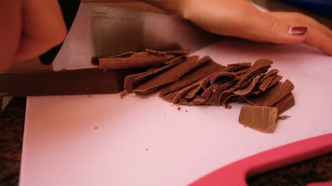 Young pastry cut into pieces a large table of chocolate, ideal footage to Stock Footage 102769651
