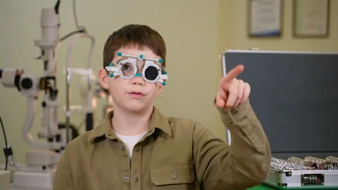 Young patient undergoing eye examination and pointing in different directions Stock Footage 310810162
