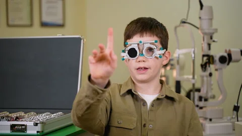 Young patient undergoing eye examination, pointing in different directions Stock Footage 310810224