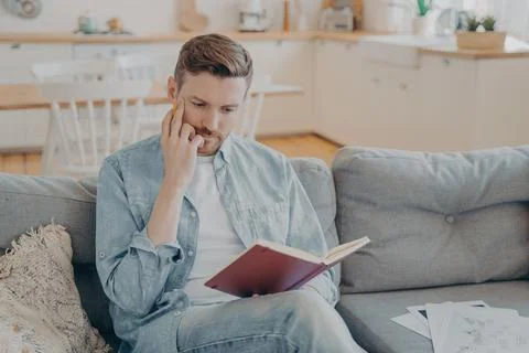 Young pensive handsome man finding new ideas and writing them down Foto stock