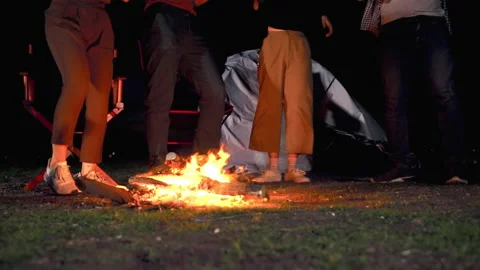 Young people are dancing around the campfire having fun at the holiday party. Stock Footage 162955733