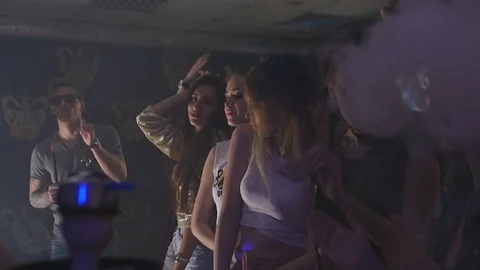 Young people are dancing at a party in a hookah bar Stock Footage 75287531