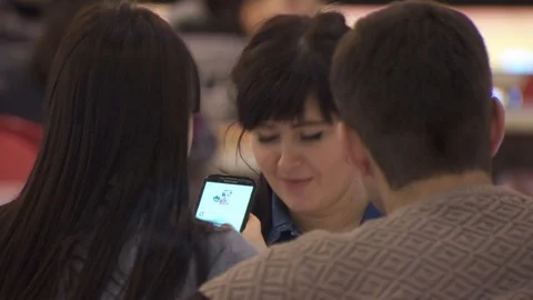 Young people are looking at the screen of a mobile phone. Video stock 113796291