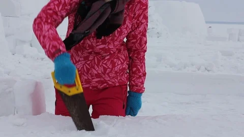 Young people builds snow Igloo with snow blocks. Stock Footage 103094041