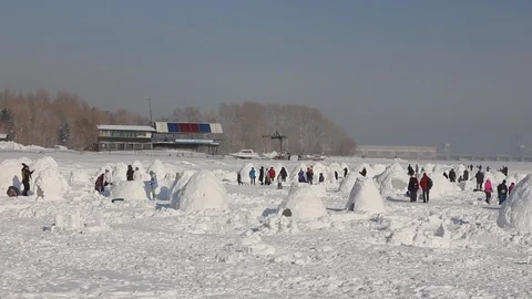 Young people builds snow Igloo with snow blocks. Winter vacation. Stock Footage 124858087