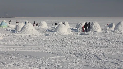 Young people builds snow Igloo with snow blocks. Winter vacation. Stock Footage 124858125