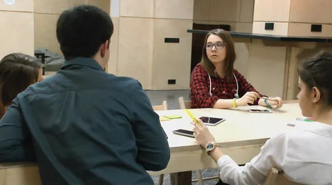Young people communicate with each other at the table Stock Footage 63364554