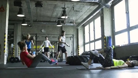 Young people in crossfit gym working out with various equipment. Stock Footage