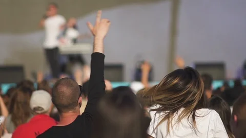 Young people dance front of stage with rock band in stadium on summer evening. Stock Footage 119906887