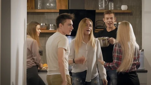 Young people dancing and having fun in kitchen Stock Footage 99093581