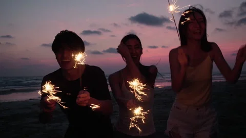 Young people dancing and playing firework summer Stock Footage 187397108