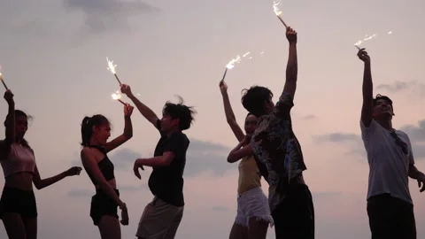 Young people dancing and playing firework summer Stock Footage 187397160