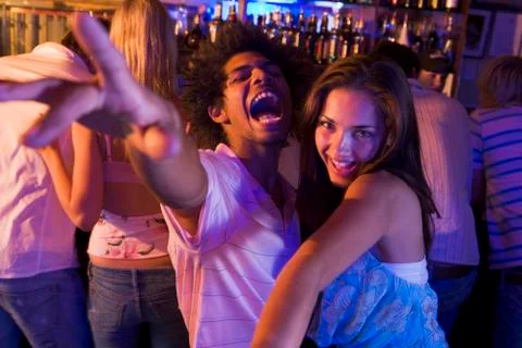 Young people dancing in a bar Stock Photos