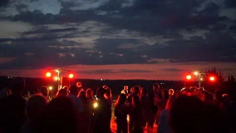 Young people dancing at a disco in the field. Sunset Stock Footage 141080153
