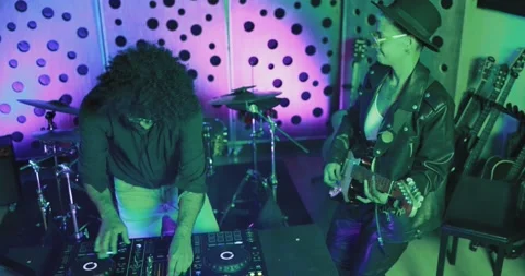 Young people dancing while record music inside a recording studio Видео 153404742