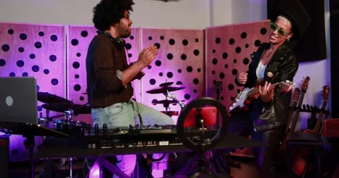 Young people dancing while record music inside a recording studio Видео 153404800