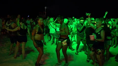 Young people from different countries dancing on the beach under the moon Stock Footage 106810891
