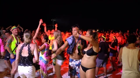 Young people from different countries dancing on the beach under the moon Stock Footage 106810910