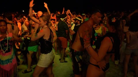 Young people from different countries dancing on the beach under the moon Stock Footage 106811042