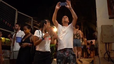 Young people from different countries dancing on the beach under the moon Stock Footage 106811173