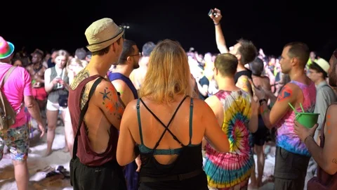 Young people from different countries dancing on the beach under the moon Stock Footage 106811413