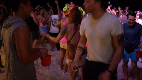Young people from different countries dancing on the beach under the moon Stock Footage 106812223