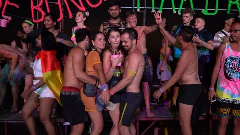Young people from different countries dancing on the beach under the moon Stock Footage 106823725