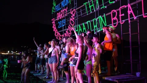 Young people from different countries dancing on the beach under the moon Stock Footage 106824455