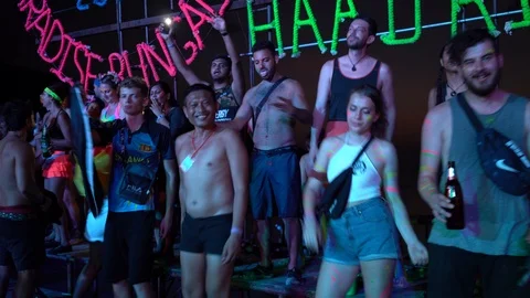 Young people from different countries dancing on the beach under the moon Stock Footage 106824595