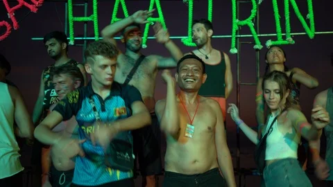 Young people from different countries dancing on the beach under the moon Stock Footage 106825004