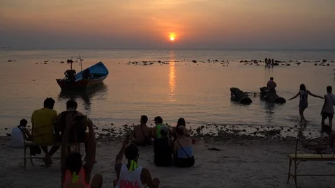 Young people from different countries meet the sunrise on Haad Rin beach Stock Footage 106969453