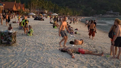 Young people from different countries meet the sunrise on Haad Rin beach Stock Footage 106970056